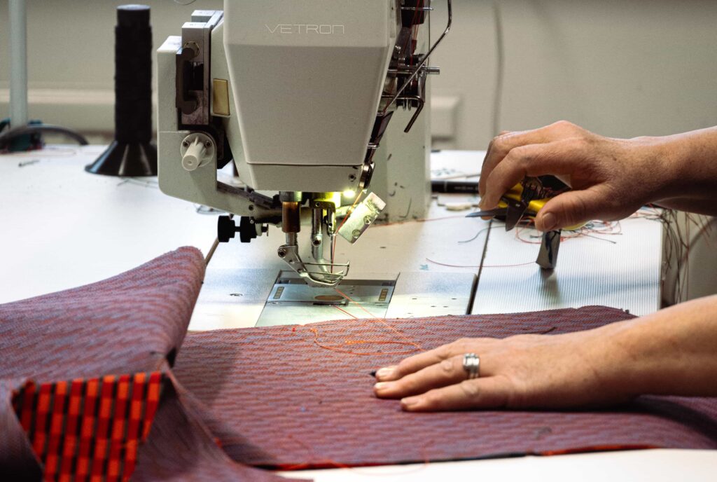 someones hands working on sewing machine